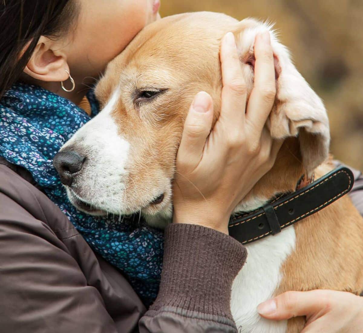 Woman with her dog tender hugs